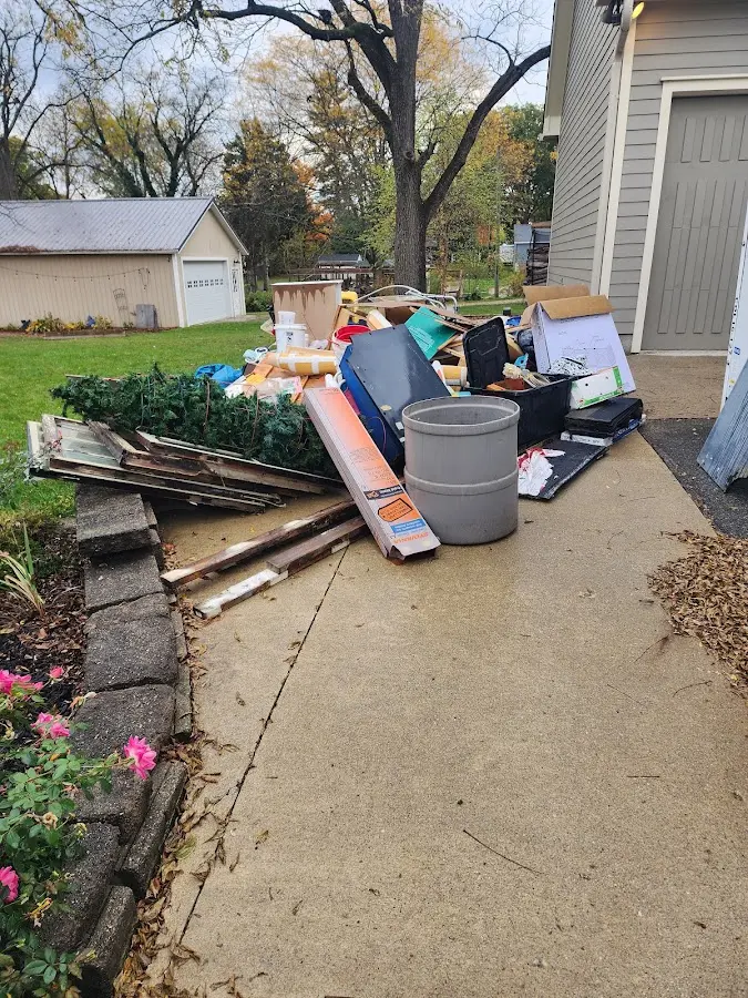 Dumpster being loaded with debris for Roofing Dumpster Rental in Minnehaha